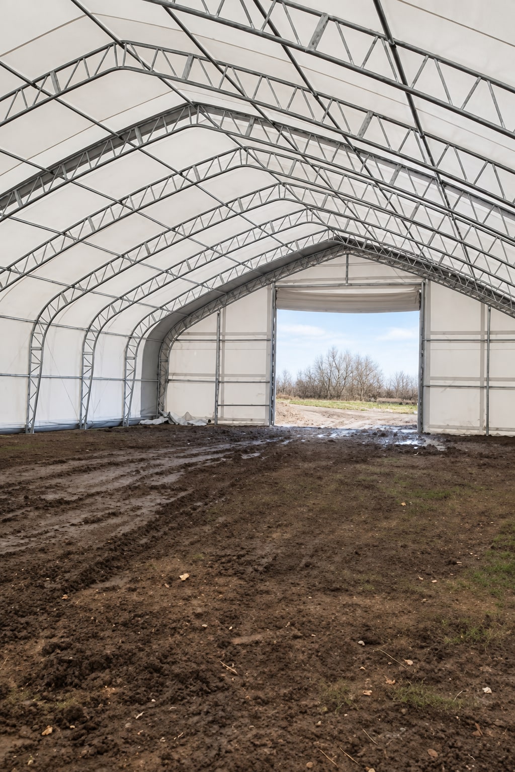 Covered interior with steel trusses and an open end doorway