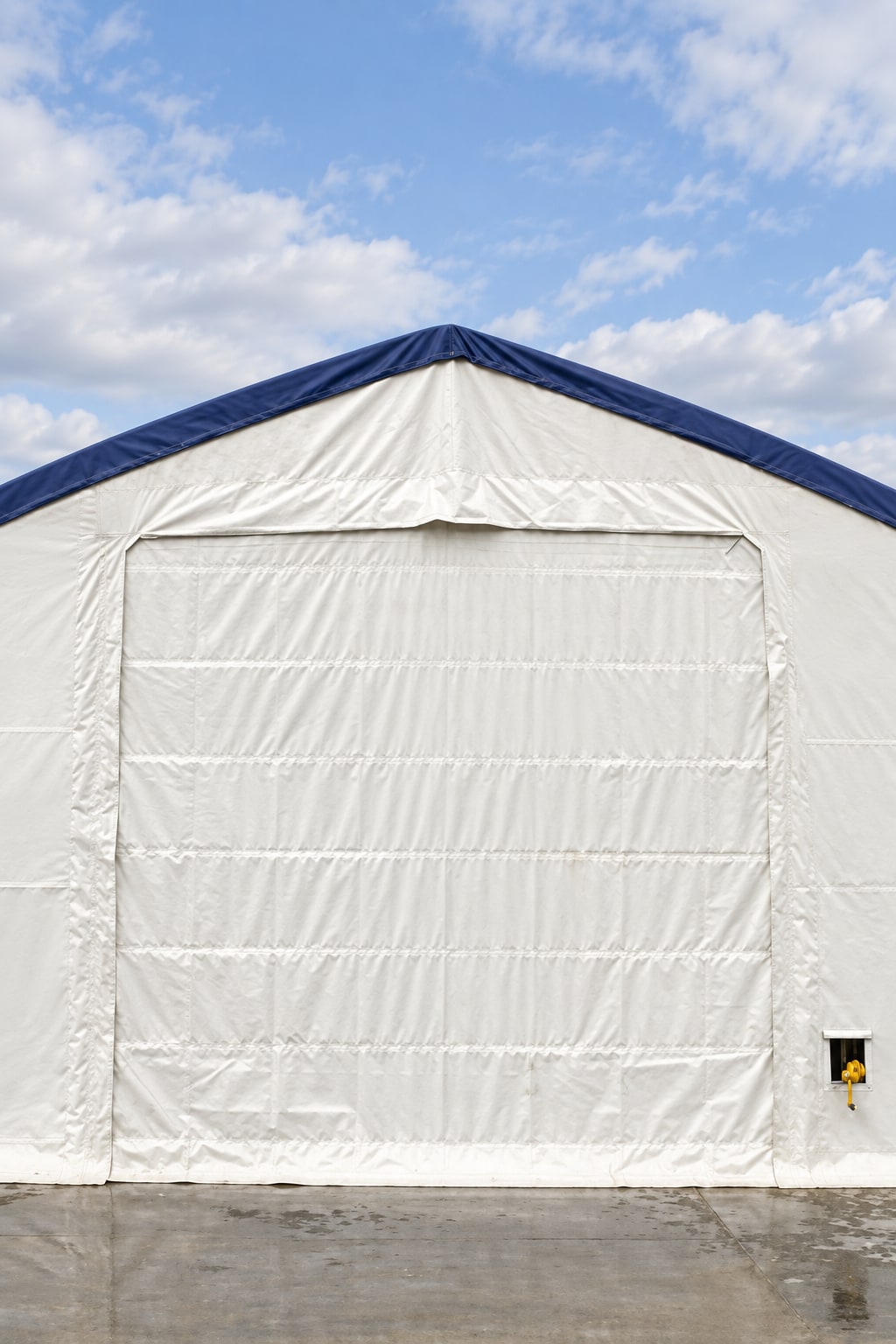 White endwall with blue trim and a closed fabric door