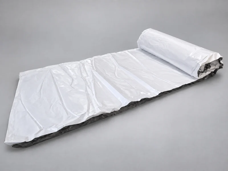 MAX DrySpan 6R20 vinyl-enclosed fibreglass insulation, partly unrolled to show its white facing and edge