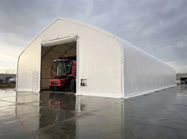 70 by 200 by 32 foot MAX Volume tall-wall fabric storage building with a combine parked inside