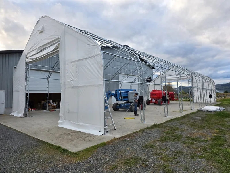 White endwall fabric installed while the roof frame remains uncovered