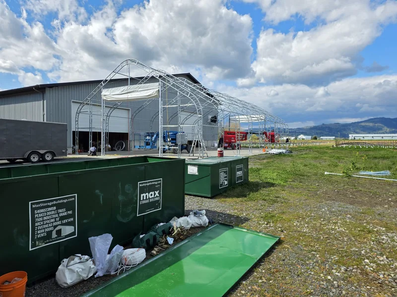 MAX component crates in front of the partly assembled building
